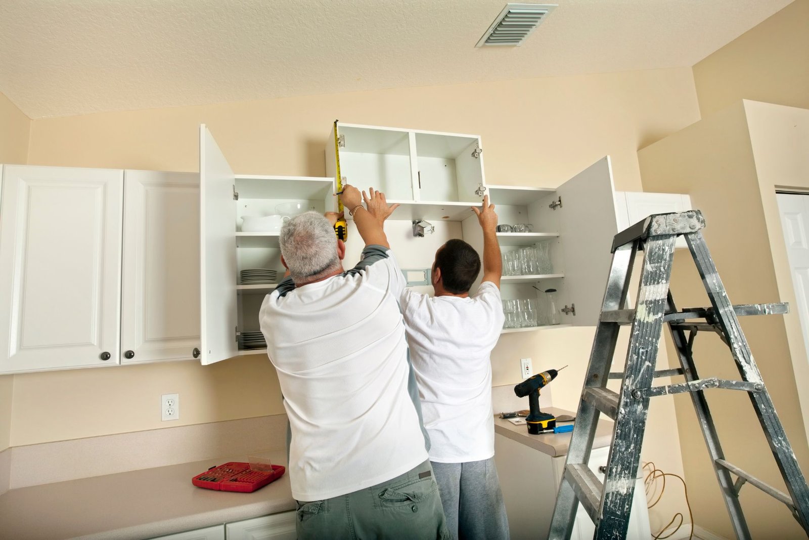 Two contractors work on a kitchen remodel on a budget